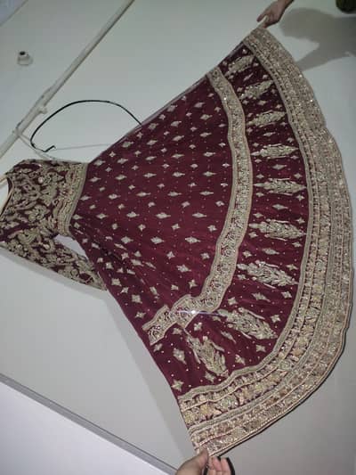 Maroon bridal dress on net. Heavily embellished and embroidered.