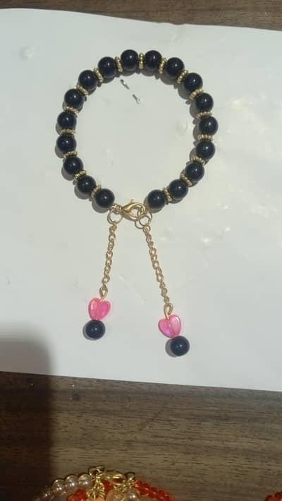 black baded bracelat with pink hart