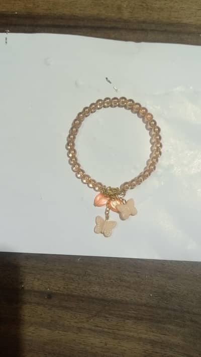 golden baded cracelet orange beterfely