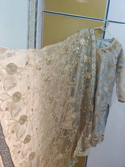 Powerder blue and gold embroidered suit with net dupatta