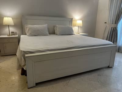 Wooden bed with side tables