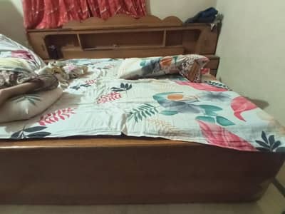 A wooden bed with two side tables