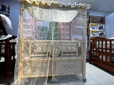 Baby cot with swing and mosquito net