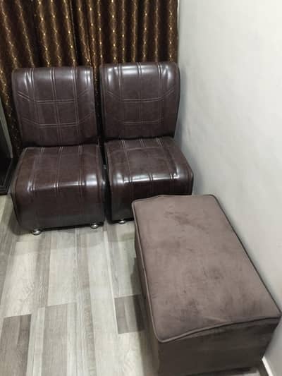 Two sofa chairs and one posish stool