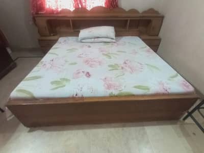 A wooden bed with two side tables
