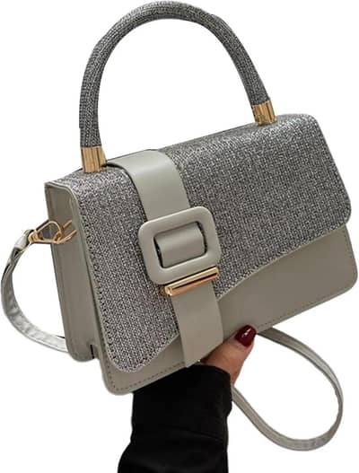 Ladies cros body bag with gold hardware .