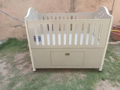 Spacious kid cot with spacious cabinet underneath.