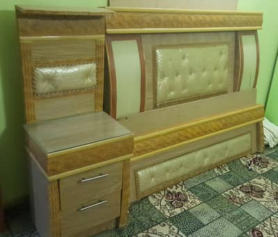 wooden double bed with one side table