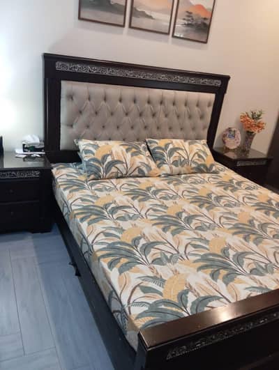 king size bed with two side tables and dressing