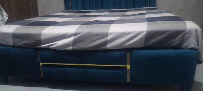wooden bed with mattress