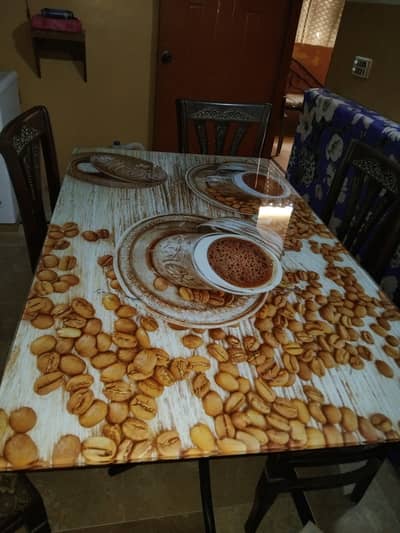 glass dining table with 6 wooden chairs