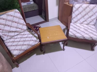 Vintage-style wooden lounge chair set with a side table