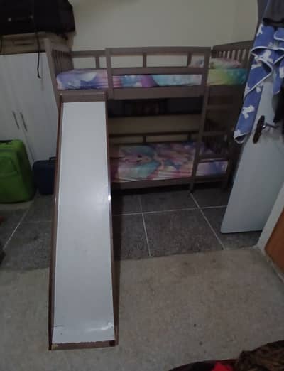 Solid wood kids bunker bed with slide and book shelves condition 10/1