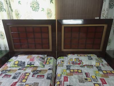 2 single beds with side tables and mattresses