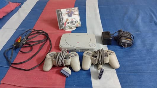 Playstation one + Fifa 2002 game (included) + Two Standard Controllers