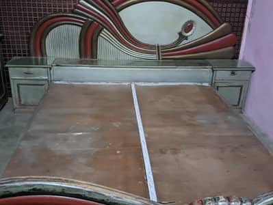 bed along with side tables and a dressing table and 2 tables