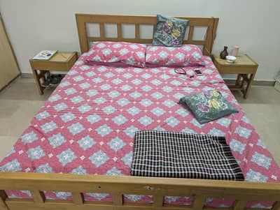 wooden bed with side tables and dressing