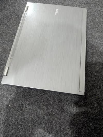 Dell laptop  with mouse and charger.