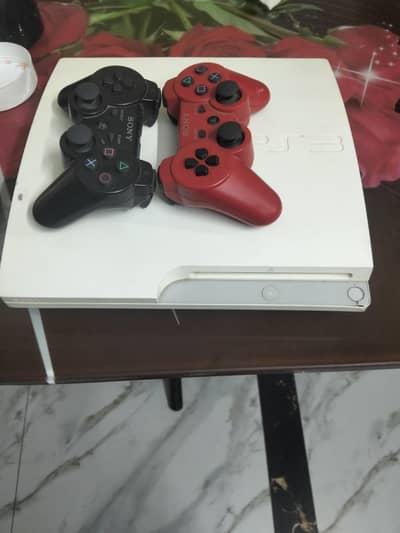PS3 WITH 17 GAMES AND TWO BOX PACK CONTROLLERZ