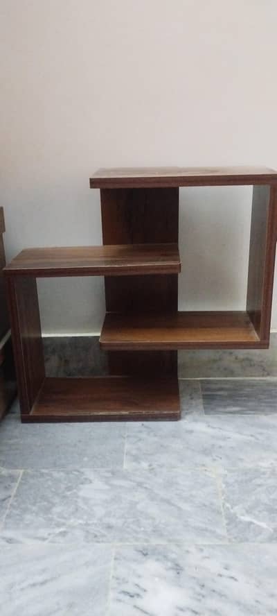 Wall mounted hanging beautiful shelf with clips behind.