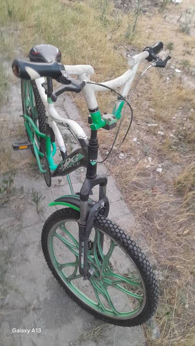 NAME:  BMX best cycle  COLOUR:  green and weight and black iron