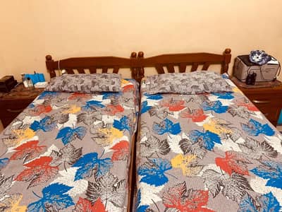 2 Single Beds with 2 side tables without mattress.