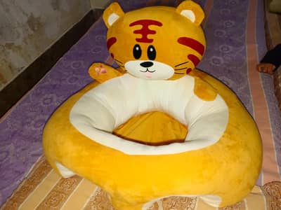 tiger-shaped sitting pillow for babies and toddlers.