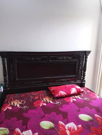 wooden bed with 2 side tables and dressing table
