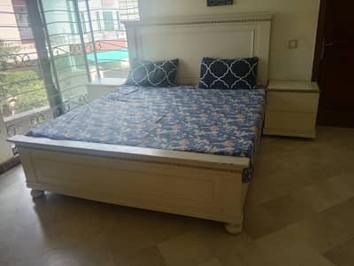 A king size bed set with two side table and a mattress of 6-7cm