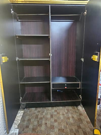 hard wood cupboard with metal Handle and lock.