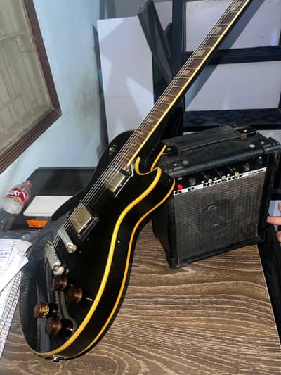Les paul style electric guitar epiphone with b. b 10 watt amplifier