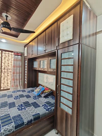 double bed set with attached wardrobes and cabinets