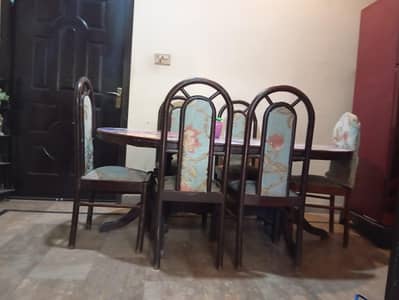 wooden dining table with six chairs