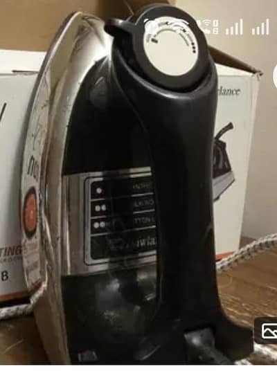 Great condition.  Black and silver coloured iron with box