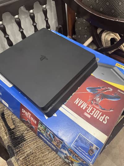 Playstation 4 slim with one controller and 2 games