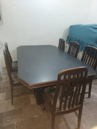 wooden dining table with six chairs