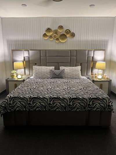 King size velvet bed with wooden side tables and dressing tables