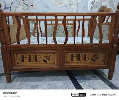 Baby cot with sufficient storage cabins .