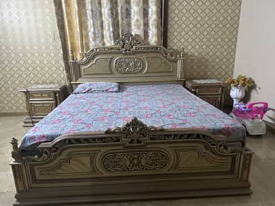 King size bed with two side tables a dressing table and a wardrobe