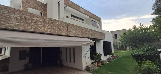 2 Kanal Top Location Bungalow (1 Kanal Lawn) With 2 Servant Quarter And Basement Is Available In The Best Block Of DHA Lahore Near Dolmen Mall.