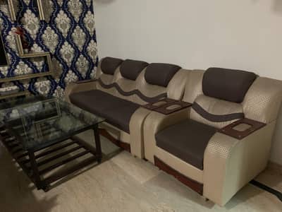 beige and brown6 seater sofa with glass centre table