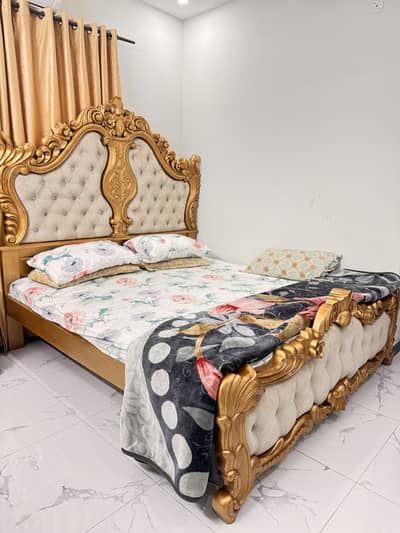 A beautiful large size bed with side table and a huge side mirror