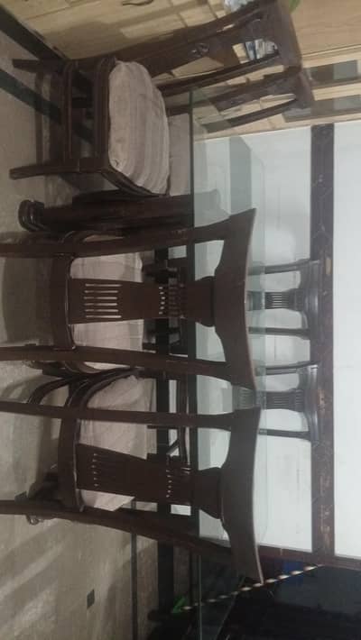 A big glass table with six chairs