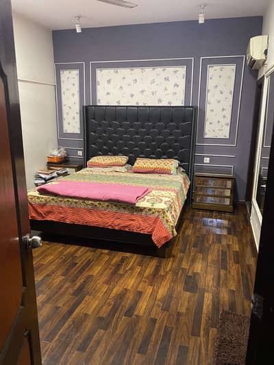 black leather bed with 2 side tables and dressing table