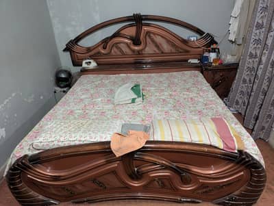 Bed, wardrobe, dressing table and side tables.