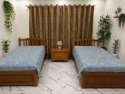 Oak wood single beds with center table and mattresses