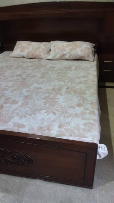 wooden bed with attached side tables and dressing