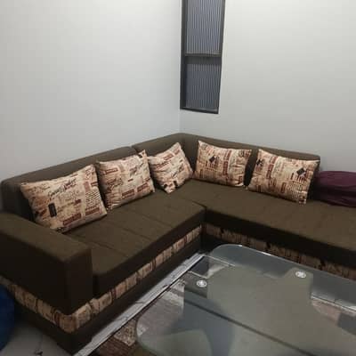 modern L shaped sofa with glass table along with 4 sitting