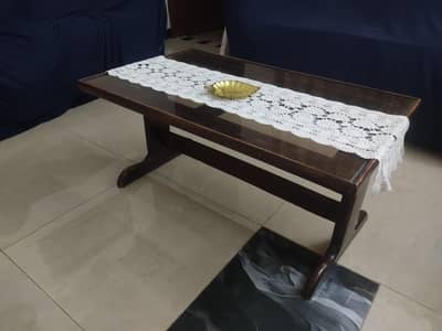 Used Wooden Center Table with glass available for sale