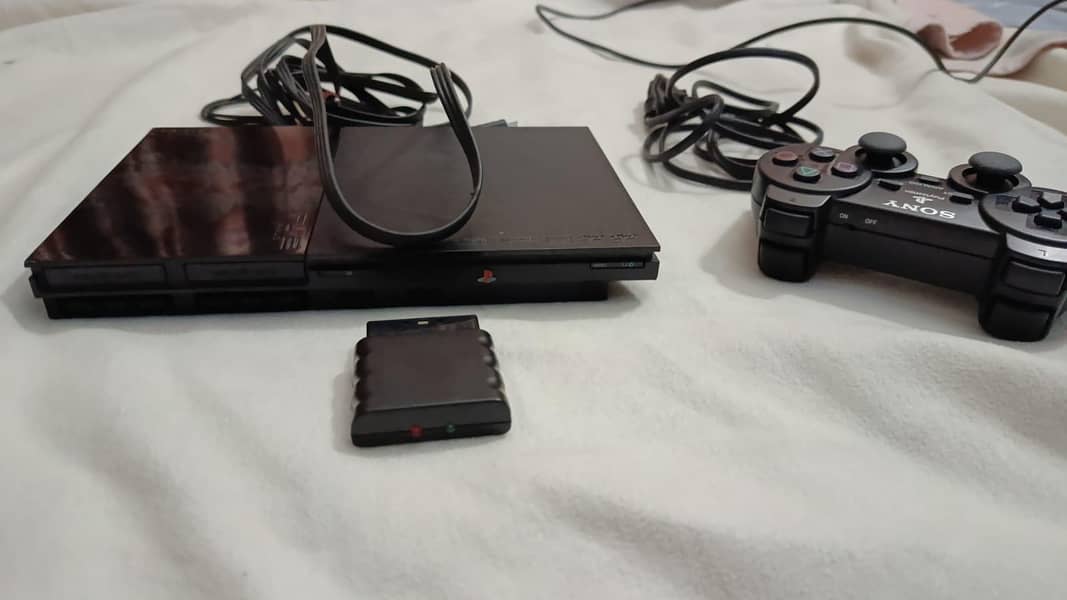 PS2 WITH 2 CD'S 1